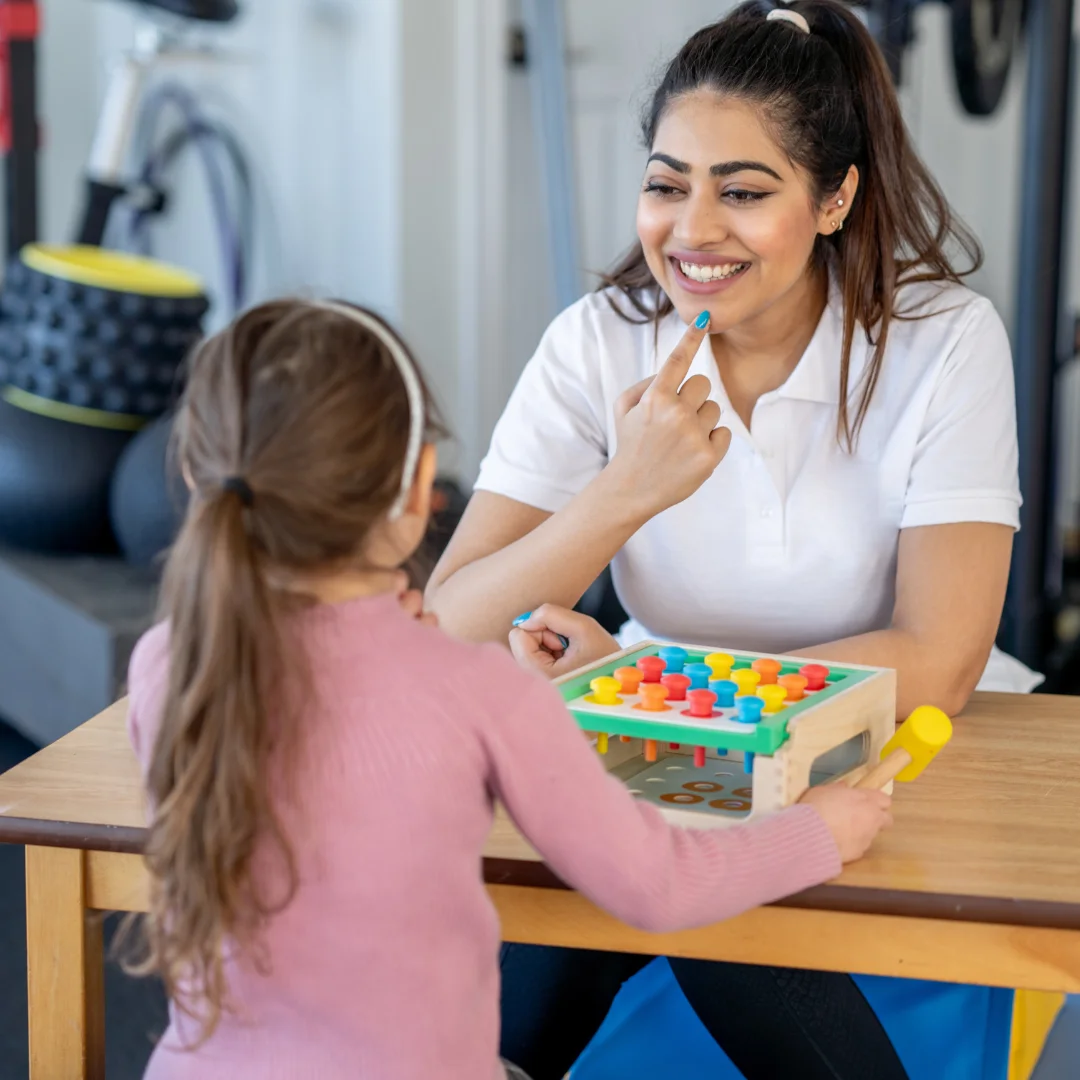 Child playing with a pegboard during an occupational therapy session